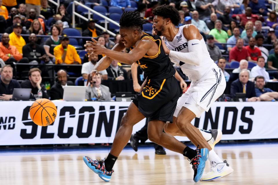 Xavier Musketeers forward Jerome Hunter (2) and Kennesaw State Owls guard Terrell Burden (1) compete for a loose ball in the first half of a first-round college basketball game between the Kennesaw State Owls and the Xavier Musketeers in the NCAA Tournament, Friday, March 17, 2023, at Greensboro Coliseum in Greensboro, N.C.