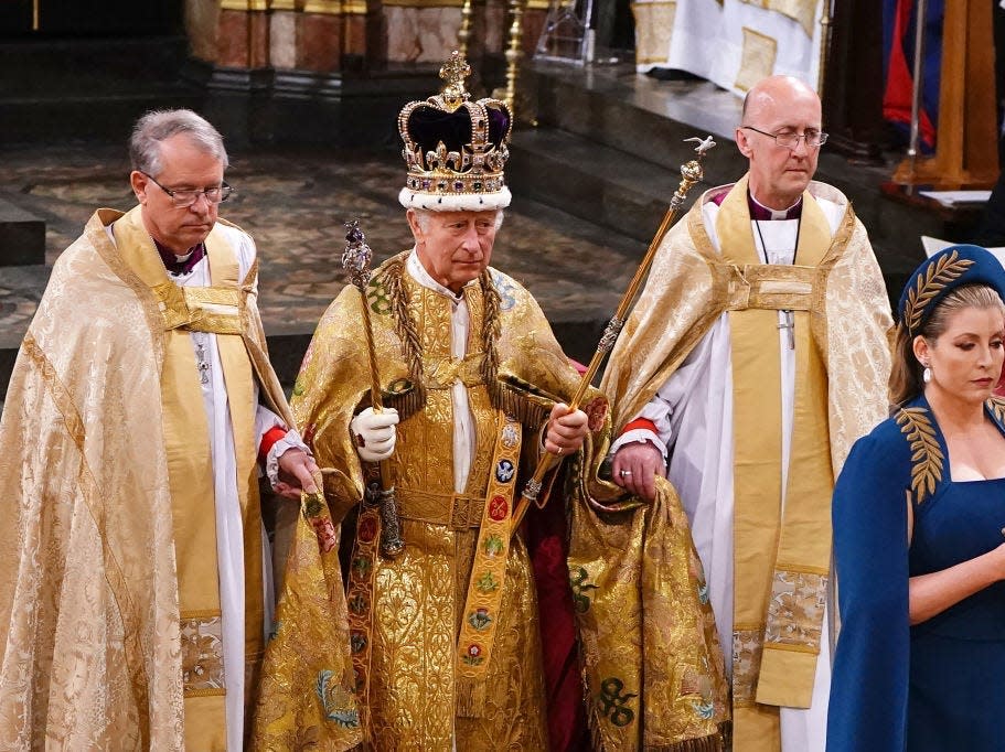 Penny Mordaunt leads King Charles III wearing the St Edward's Crown during his coronation ceremony in Westminster Abbey on May 6, 2023 in London, England.