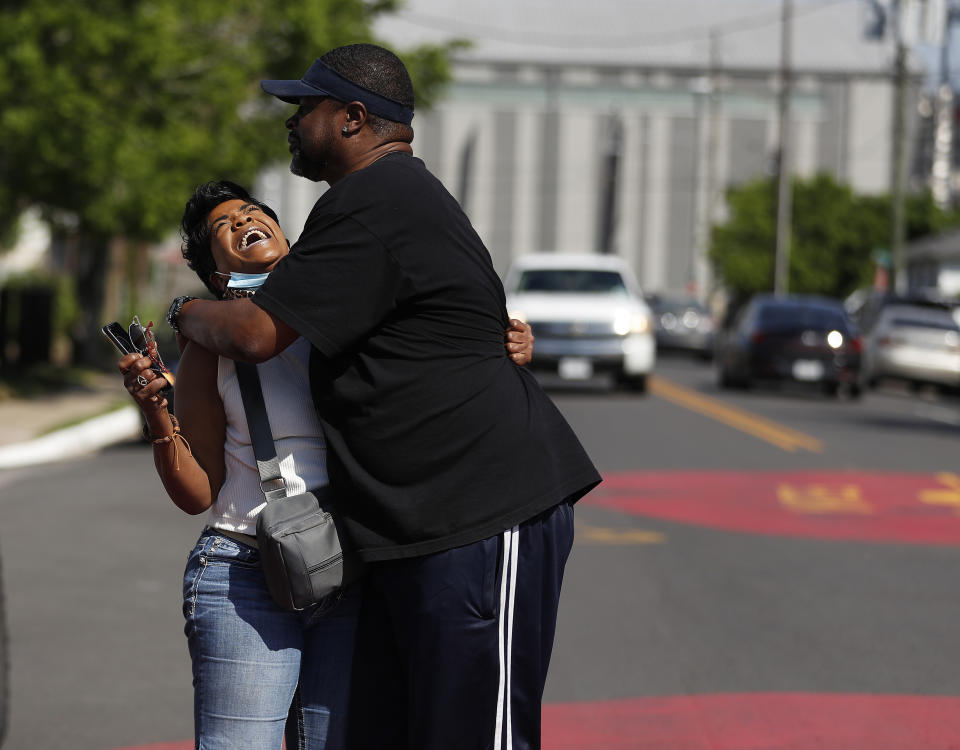 Ceci Munoz reacts with Dennis Glenn at Yates High School as they learn the guilty verdict on all counts in the murder trial of former Minneapolis police Officer Derek Chauvin in the death of George Floyd, Tuesday, April 20, 2021, in Houston. A jury convicted Chauvin today on murder and manslaughter charges. (Karen Warren/Houston Chronicle via AP)