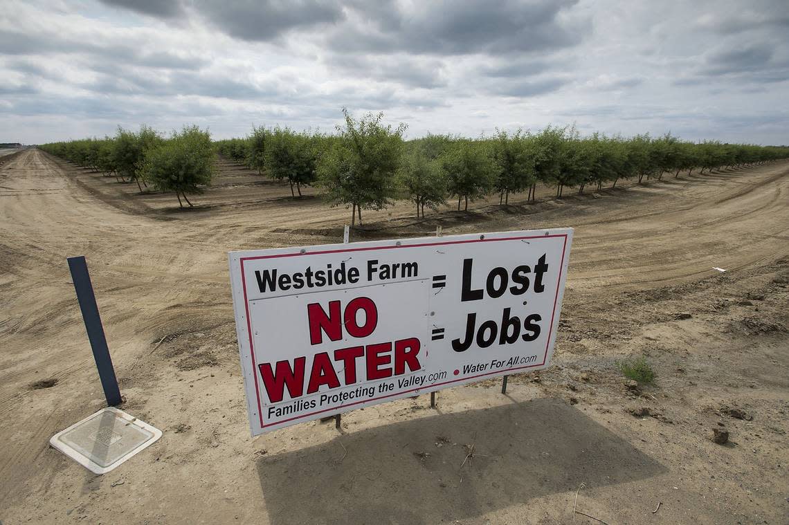 Signs like this one dot the landscape around farms near Huron on Fresno County’s west side.