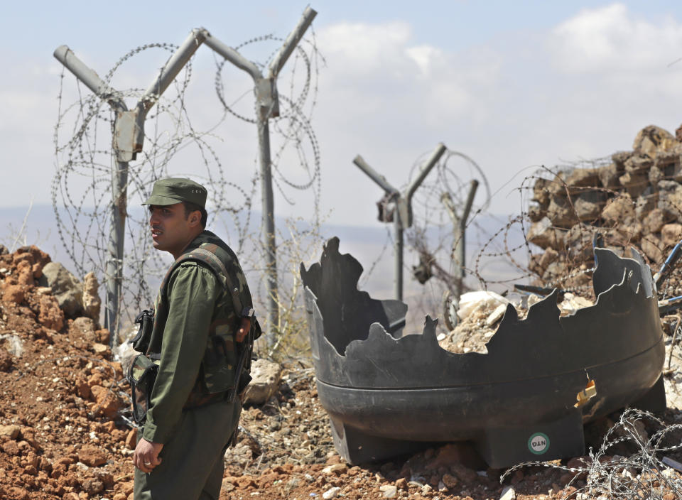 Syrian army soldier stands guard at post near village of Tal Kroum, Syria, Tuesday, Aug. 14, 2018. The Russian military said Tuesday that its forces in Syria will help U.N. peacekeepers fully restore patrols along the frontier with the Israeli-occupied Golan Heights, reflecting Moscow's deepening role in mediating between the decades-old foes. (AP Photo/Sergei Grits)