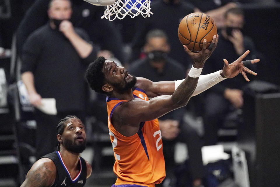 Phoenix Suns center Deandre Ayton, right, shoots as Los Angeles Clippers guard Paul George defends during the first half in Game 6 of the NBA basketball Western Conference Finals Wednesday, June 30, 2021, in Los Angeles. (AP Photo/Mark J. Terrill)