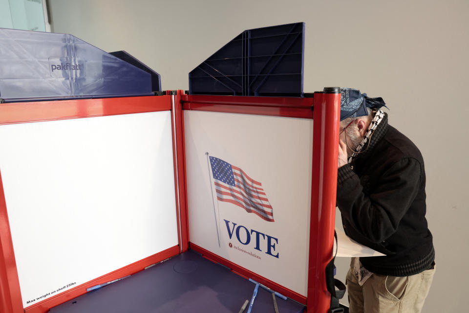 People cast their ballots during early voting in the state's primary on the campus of the University of Michigan in Ann Arbor, Michigan on February 20, 2024.