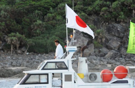 A boat, part of a 20-boat flotilla carrying activists and lawmakers including Japanese nationalists, arrives at a group of disputed islands known as Senkaku in Japan and Diaoyu in China, on August 19