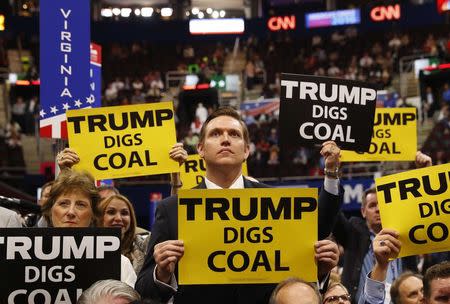 Delegates from West Virginia hold signs supporting coal on the second day of the Republican National Convention in Cleveland, Ohio, U.S. July 19, 2016. REUTERS/Aaron P. Bernstein/File Photo