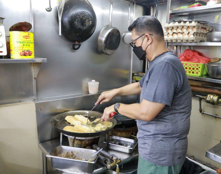 roti john - cook in the kitchen preparing