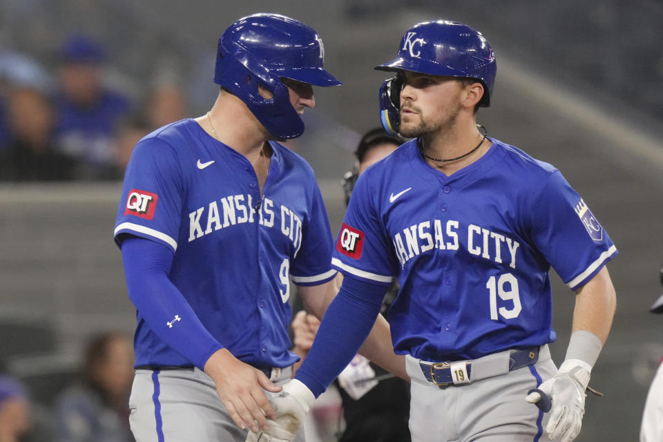 Kansas City Royals' Michael Massey (19) is greeted by Vinnie Pasquantino (9) as he crosses home plate after hitting a three-run home run in the eighth inning of a baseball game against the Toronto Blue Jays in Toronto, Wednesday, May 1, 2024. (Chris Young/The Canadian Press via AP)