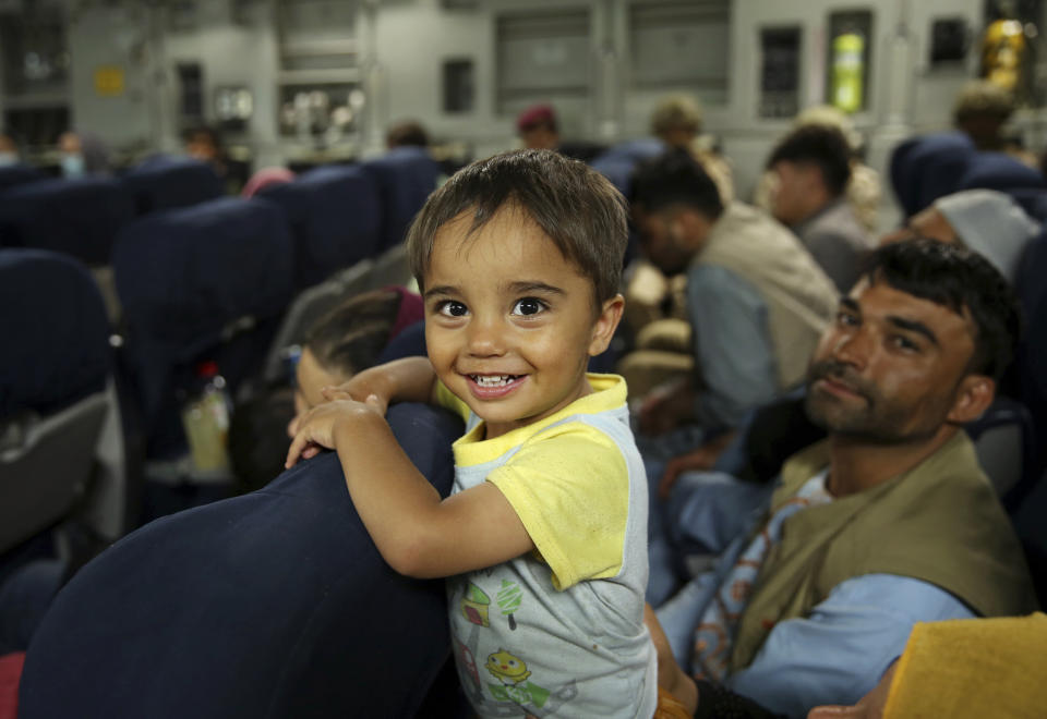 Afghans prepare to to be evacuated aboard a Qatari transport plane, at Hamid Karzai International Airport in Kabul, Afghanistan, August, 18, 2021. Qatar played an out-sized role in U.S. efforts to evacuate tens of thousands of people from Afghanistan. Now the tiny Gulf Arab state is being asked to help shape what is next for Afghanistan because of its ties with both Washington and the Taliban insurgents now in charge in Kabul. (Qatar Government Communications Office via AP)