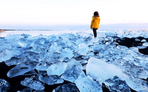 Washed up icebergs litter Diamond Beach, beside the lagoon - Credit: getty