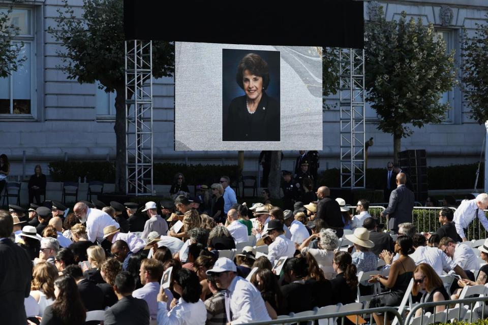 Mourners gather