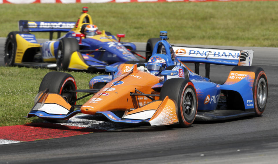 Scott Dixon races his car ahead of Alexander Rossi during the IndyCar Series auto race, Sunday, July 28, 2019, at Mid-Ohio Sports Car Course in Lexington, OH. (AP Photo/Tom E. Puskar)