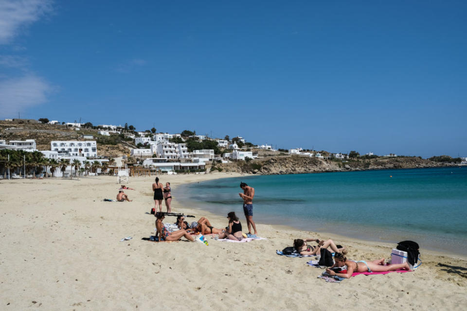 A small group of beachgoers at Platis Gialos Beach, Mykonos.