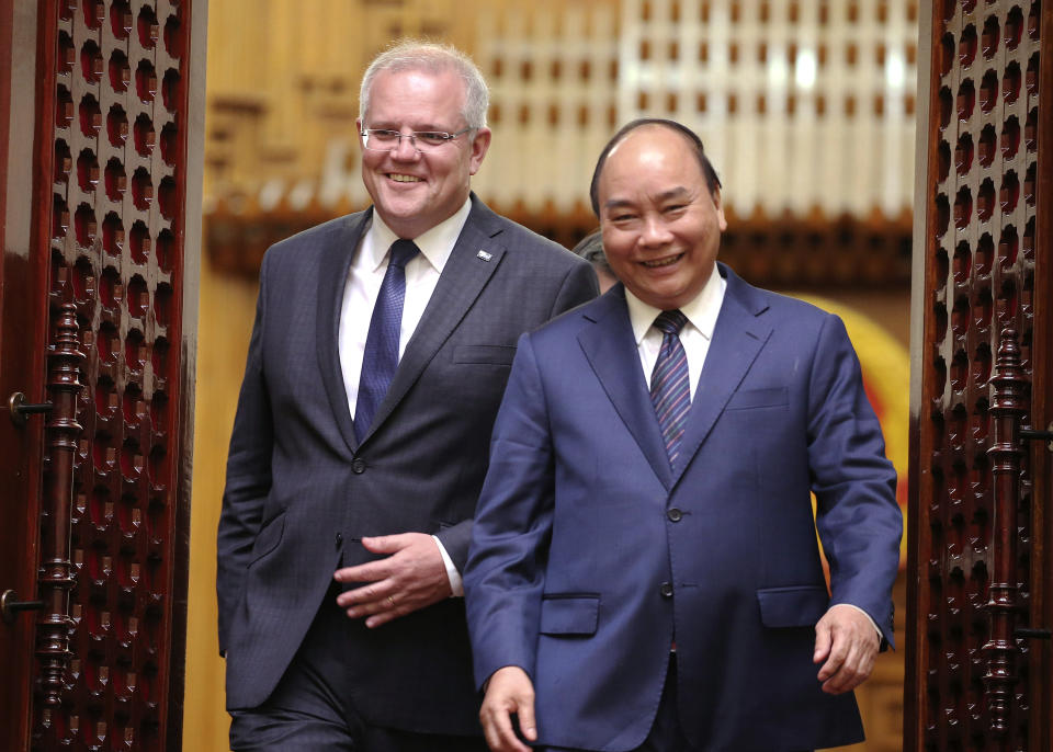 Australian Prime Minister Scott Morrison, left, and his Vietnamese counterpart Nguyen Xuan Phuc walk to a press briefing at the Government Office in Hanoi, Vietnam, Friday, Aug. 23, 2019. (AP Photo/Duc Thanh)