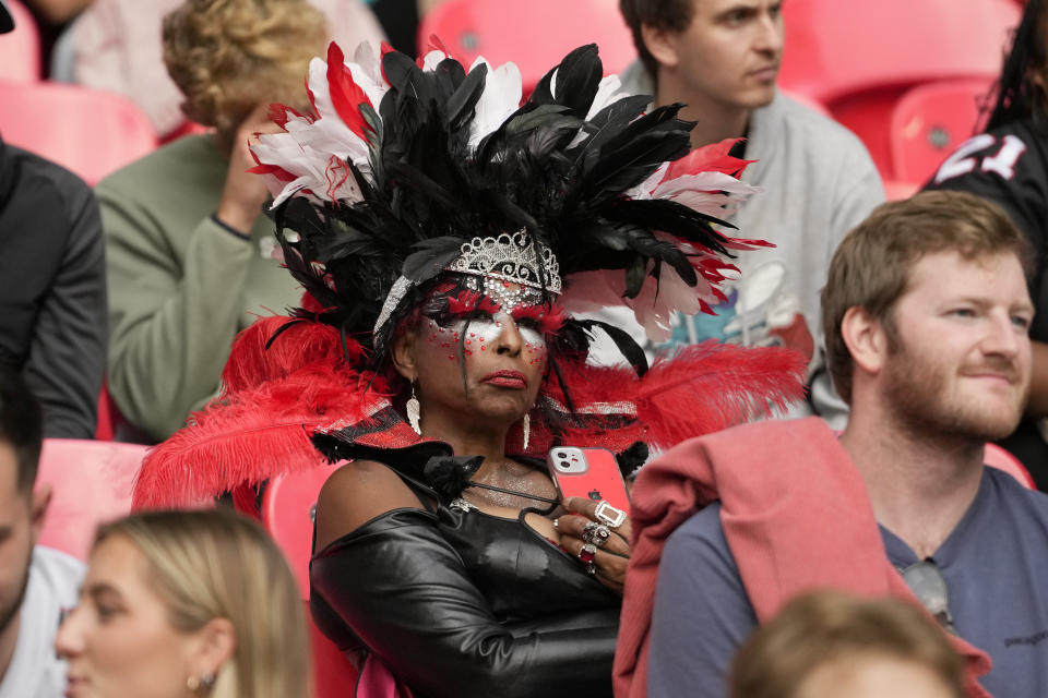 A supporter watches from the stands during an NFL football game between the Atlanta Falcons and the Jacksonville Jaguars at Wembley stadium in London, Sunday, Oct. 1, 2023. (AP Photo/Kirsty Wigglesworth)