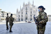 Soldiers patrol in front of the Duomo gothic cathedral in Milan, Italy, Sunday, April 5, 2020. The government is demanding Italians stay home and not take the leveling off of new coronavirus infections as a sign the emergency is over, following evidence that more and more Italians are relaxing restrictions the west’s first and most extreme nationwide lockdown and production shutdown. (Claudio Furlan/LaPresse via AP)