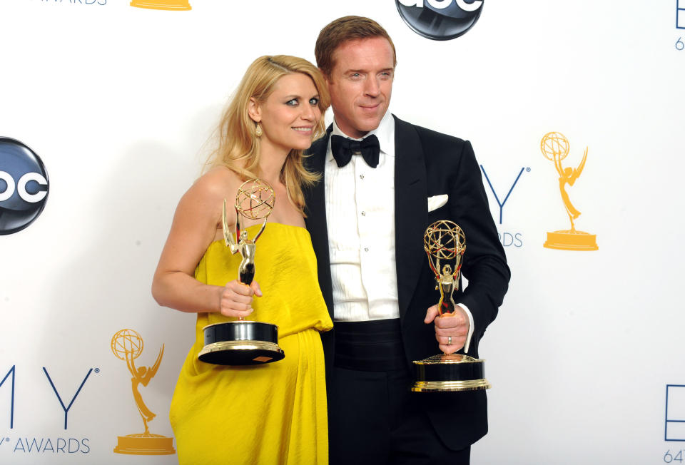 Actress Claire Danes, winner of the Emmy for outstanding lead actress in a drama series for "Homeland," left, and actor Damien Lewis, winner of the Emmy for outstanding lead actor in a drama series for "Homeland" pose together backstage at the 64th Primetime Emmy Awards at the Nokia Theatre on Sunday, Sept. 23, 2012, in Los Angeles. (Photo by Jordan Strauss/Invision/AP)