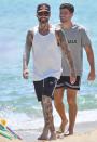 <p>Maroon 5 frontman Adam Levine shares a smile while enjoying a beach walk in Saint-Tropez, France, with a friend on July 2.</p>