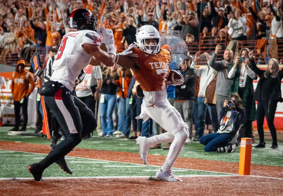 Texas running back Keilan Robinson scores the first touchdown of the game Friday night in the Longhorns' 57-7 win over Texas Tech. He later added a 95-yard kickoff return score to open the second half.