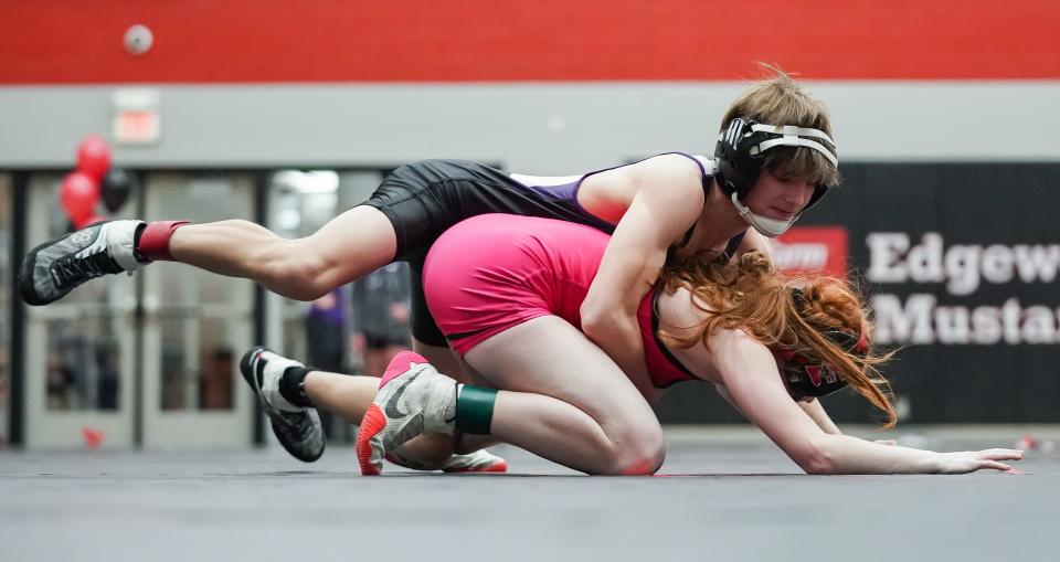 Bloomington South’s Jaxsen Jean (top) wrestles against Edgewood’s Katelyn Holmes in the 106-pound match during their dual meet at Edgewood on Thursday, Jan. 18, 2024.