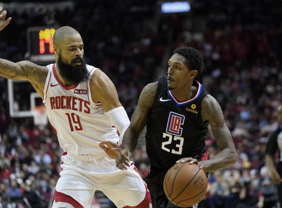 LA Clippers' Lou Williams (23) drives toward the basket as Houston Rockets' Tyson Chandler (19) defends during the first half of an NBA basketball game Wednesday, Nov. 13, 2019, in Houston. (AP Photo/David J. Phillip)