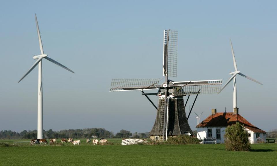 Baburenmolen windmill alongside modern wind turbines in Bolsward, Friesland, the Netherlands.