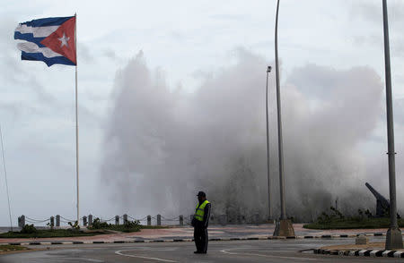 A police officer stands on the seafront boulevard El Malecon ahead of the passing of Hurricane Irma, in Havana, Cuba September 9, 2017. REUTERS/Stringer