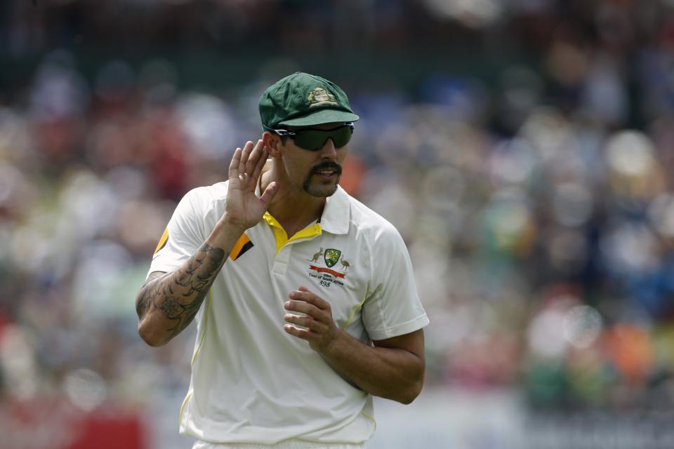 Australia's Mitchell Johnson responds to comments from South African supporters during the fourth day of their first cricket test match in Pretoria, February 15, 2014. REUTERS/Mike Hutchings (SOUTH AFRICA - Tags: SPORT CRICKET)