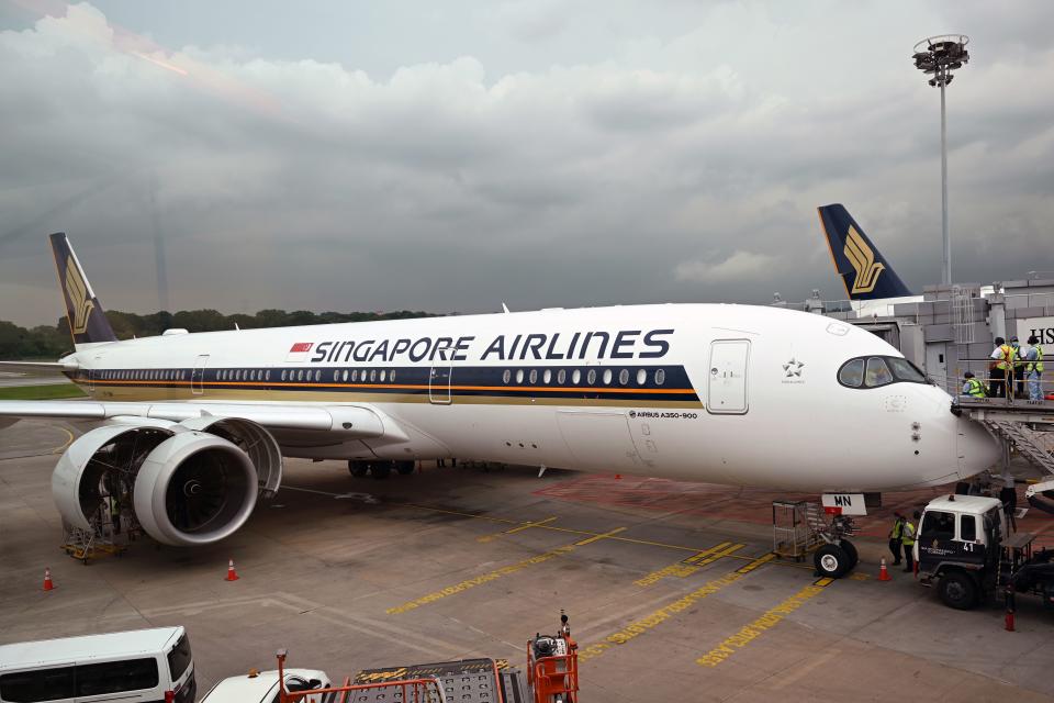 Technicians check on a Singapore Airlines Airbus A350-900 plane at Changi International Airport in Singapore on October 24, 2020. (Photo by ROSLAN RAHMAN / AFP) (Photo by ROSLAN RAHMAN/AFP via Getty Images)