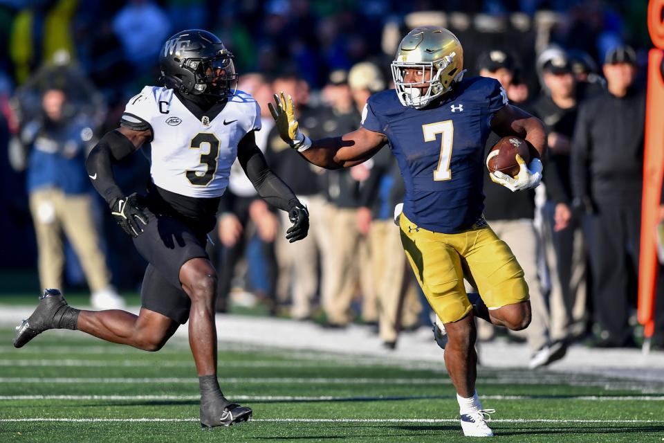 Nov 18, 2023; South Bend, Indiana, USA; Notre Dame Fighting Irish running back Audric Estime (7) runs the ball as Wake Forest Demon Deacons safety Malik Mustapha (3) defends in the first quarter at Notre Dame Stadium. Mandatory Credit: Matt Cashore-USA TODAY Sports