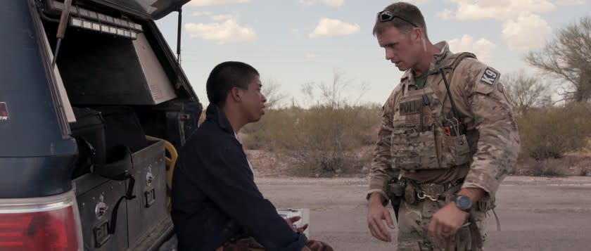 A migrant, left, seeking help in Tucson's desert in a moment from Netflix's "Immigration Nation."