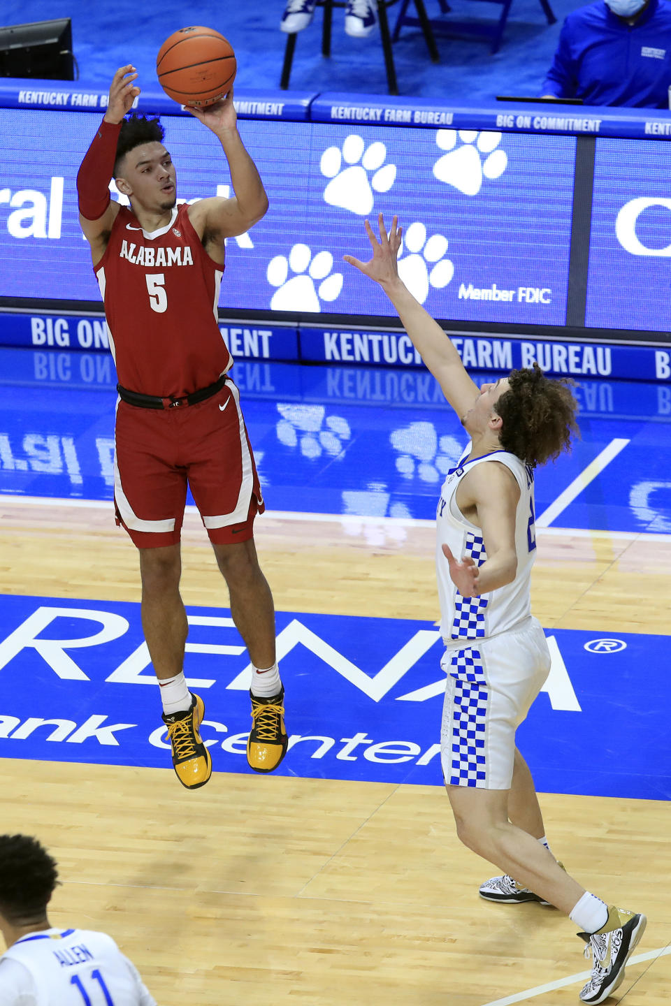 Alabama's Jaden Shackelford (5) shoots a 3-pointer over Kentucky's Devin Askew during the first half of an NCAA college basketball game in Lexington, Ky., Tuesday, Jan. 12, 2021. (AP Photo/James Crisp)