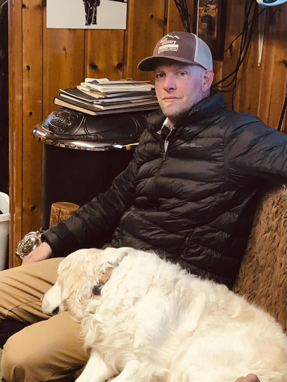 In this photo provided by Jerry D. Johnson, Charles "Carl" Mock is seen in an undated photo inside the offices of Backcountry Adventures, a guided snowmobile tour company that he worked at in West Yellowstone, Mont. Mock died over the weekend after being mauled by a grizzly bear just outside Yellowstone National Park. (Jerry D. Johnson via AP)