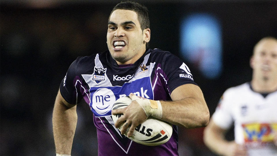 Greg Inglis running with the ball towards the tryline.