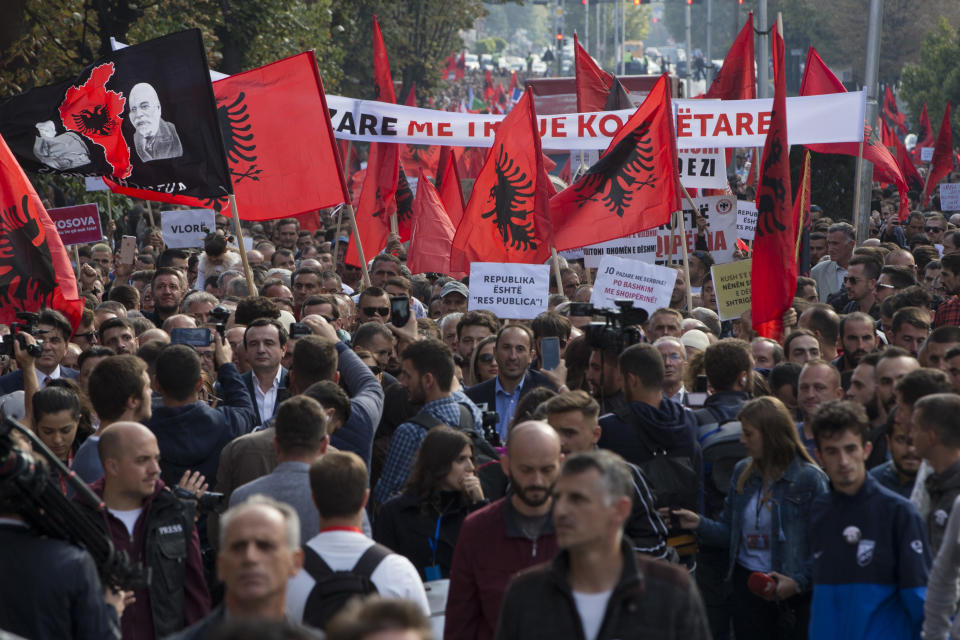 Thousands of supporters of Kosovo's opposition Self-Determination party hold banners and national Albanian flags as they march toward Skanderbeg Square on Saturday, Sept. 29, 2018, in Kosovo capital Pristina. Thousands of people in Kosovo are protesting their president's willingness to include a possible territory swap with Serbia in the ongoing negotiations to normalize relations between the two countries.(AP Photo/Visar Kryeziu)