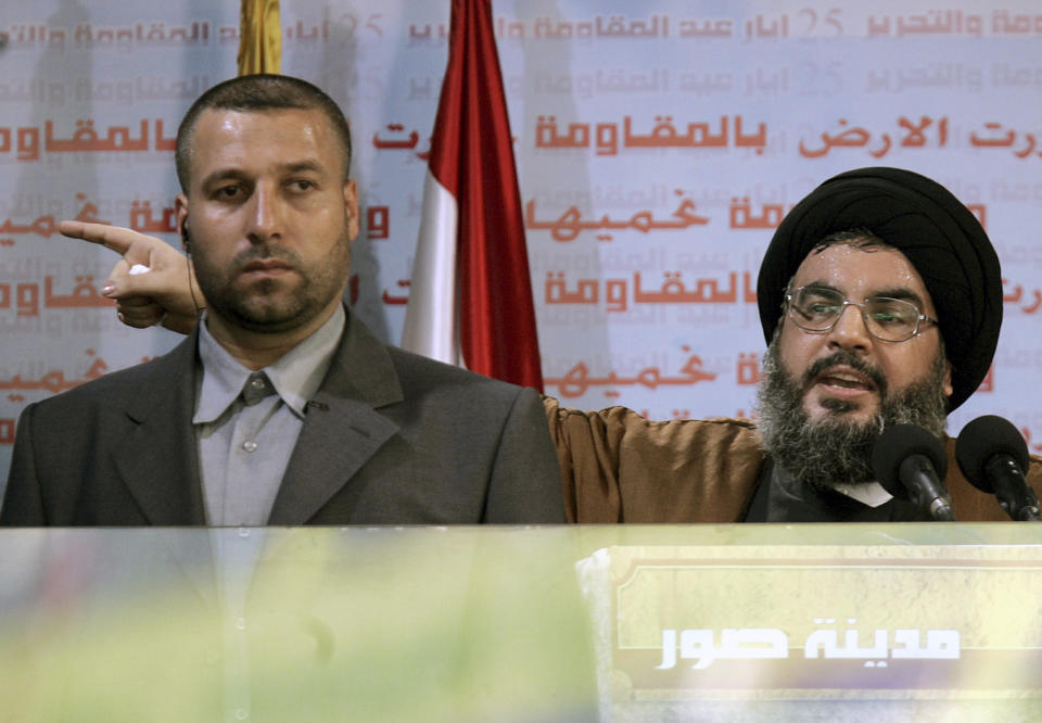 FILE - Hezbollah leader Sayyed Hassan Nasrallah, right, gives an address while accompanied by his bodyguard Yasser Nemr Qranbish, during a rally to mark the sixth anniversary of Israel's withdrawal from southern Lebanon after an 18-year occupation, in the southern port city of Tyre, Lebanon, on May 25, 2006. An Israeli strike in Syria Tuesday July 9, 2024 killed Qranbish, a former personal bodyguard of Hezbollah leader, an official with the Lebanese militant group said. (AP Photo/Hussein Malla, File)