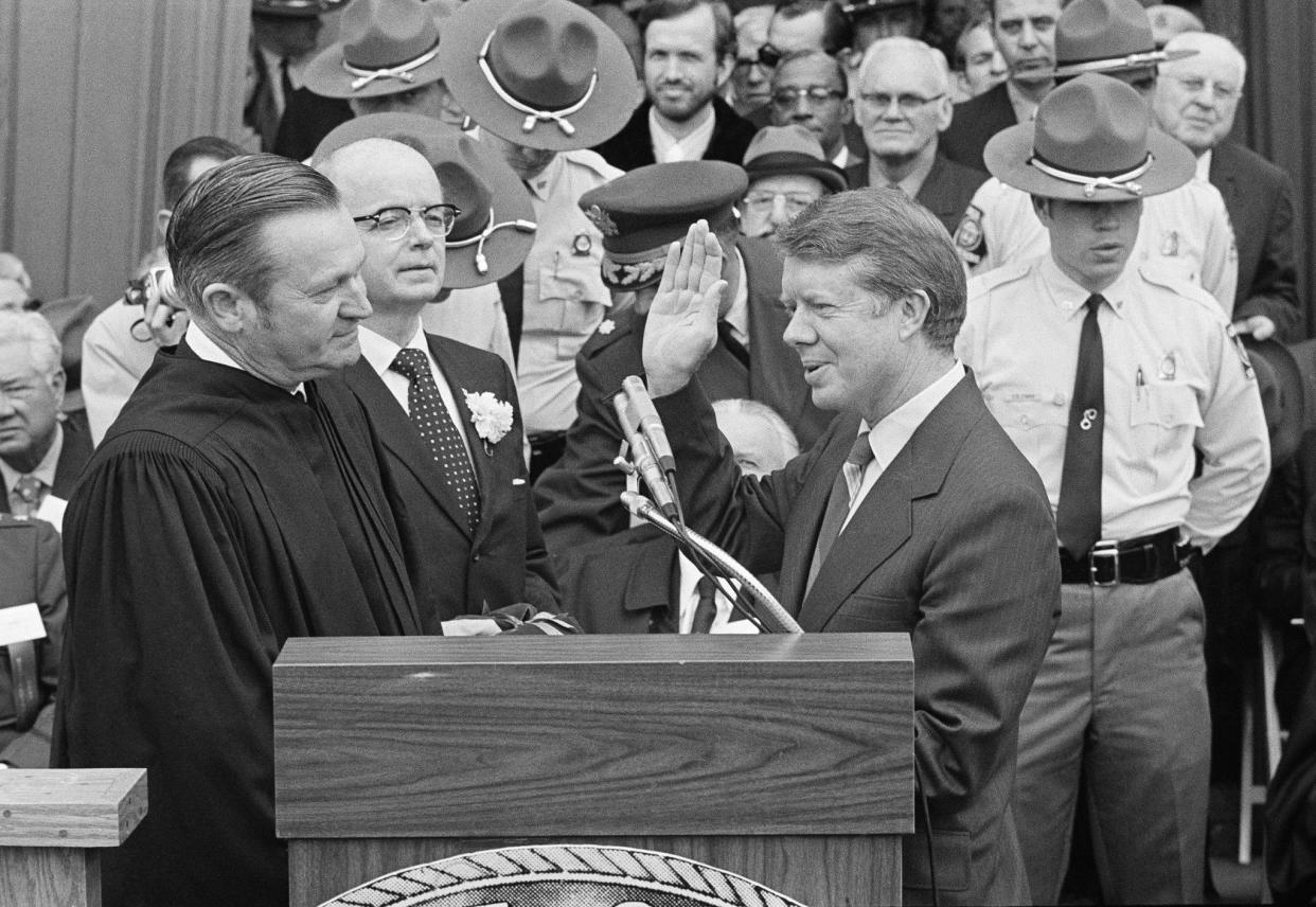 Judge Robert H. Jordan administers the oath of office to Gov. Jimmy Carter during ceremonies at the state capitol on Jan. 12, 1971, in Atlanta. Ga. Former Gov. Lester Maddox, center, will become the lieutenant governor of Georgia.