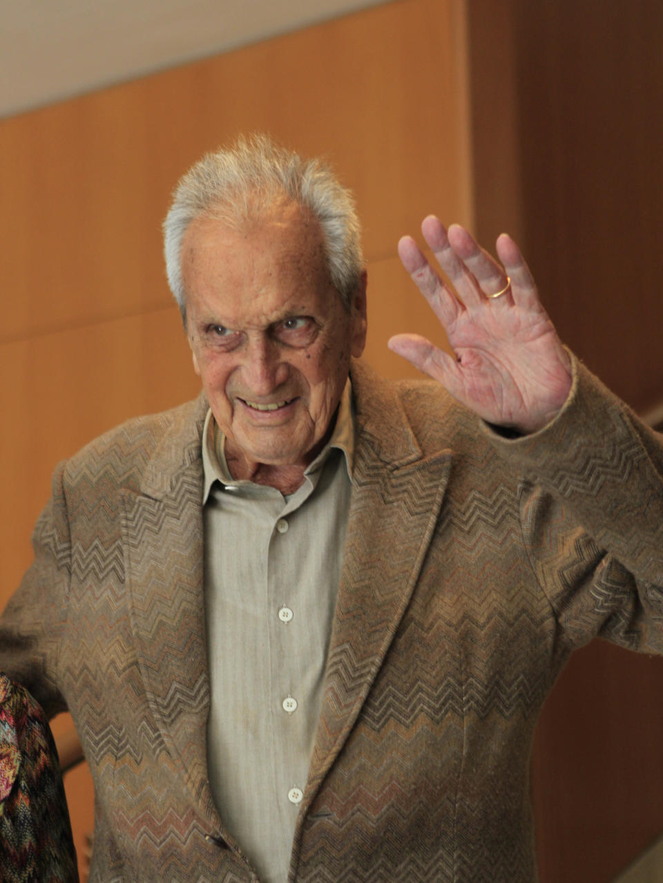 In this photo taken on March 22, 2012 Italian fashion designer Ottavio Missoni waves as he attends a journalism prize event in Milan, Italy. Italian fashion company Missoni says its co-founder, Ottavio Missoni, has died in his home earlier on Thursday, May 9, 2013 in northern Italy. Missoni, who was 92, founded the iconic fashion brand of zigzagged-patterned knitwear along with his wife, Rosita, in 1953. The Missonis are a family fashion dynasty, with the couple’s children and their offspring involved in expanding the brand. (AP Photo/Luca Bruno)