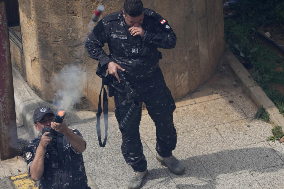 Lebanese soldier from the Government Guard unit, fires tear gas against retired army soldiers and other protesters who are protesting demanding better pay, in Beirut, Lebanon, Wednesday, March 22, 2023. Lebanese security forces are firing tear gas to disperse hundreds of protesters who tried to break through a fence leading to the government headquarters in downtown Beirut. The protest comes amid widespread anger over the harsh economic conditions in the country. (AP Photo/Hussein Malla)