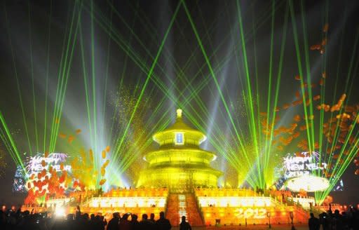 People gather to celebrate the new year 2012 at the Temple of Heaven, the city's historic landmark in Beijing. Spectacular fireworks and crowded parties will ring in the New Year for revellers around the world, as billions mark the end of 2011 with noisy celebrations from Sydney to Stockholm