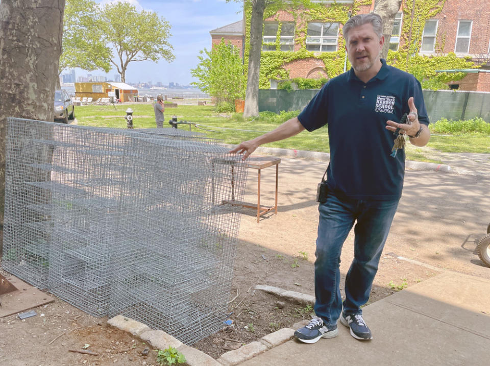Harbor School principal Jeff Chetirko stands next to cages — they’ll be filled with oysters in support of the Billion Oyster Project — built by students. (Eamonn Fitzmaurice)