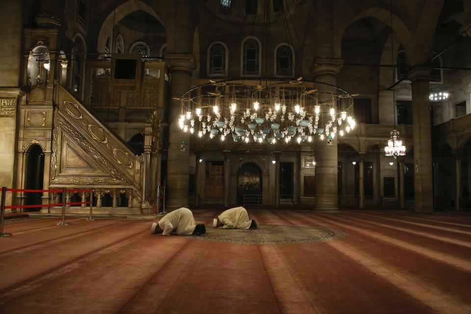 Imam of Eyup Sultan Mosque, Hasan Tok and Imam Metin Cakar hold a prayer for coronavirus in Istanbul, Friday, April 3, 2020. After the fifth and final call to prayer of the day in Muslim Turkey, imams around the country have been asked to perform an additional prayer asking for God's mercy and protection during the novel coronavirus pandemic. Calls echoed across the city of Istanbul, Turkey's largest, where thousands of people have been infected with the virus.
