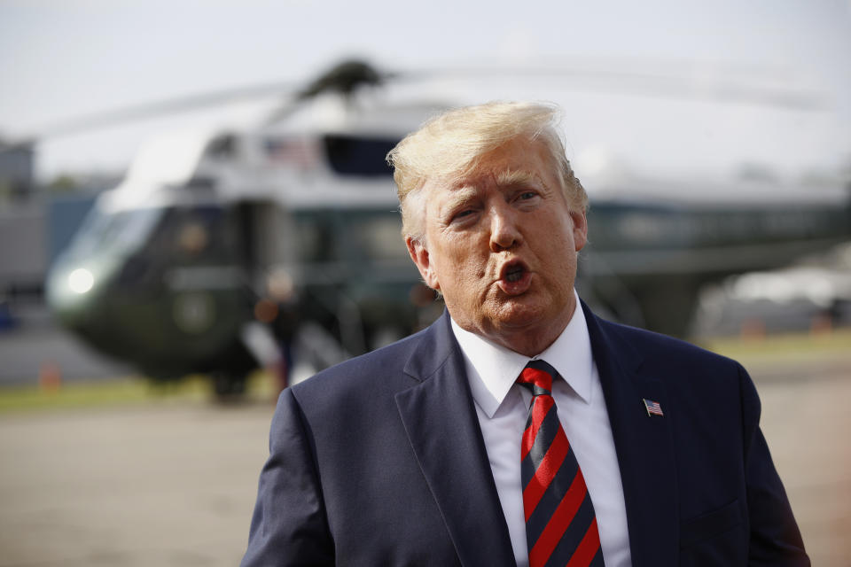 President Donald Trump speaks with reporters before boarding Air Force One at Morristown Municipal Airport in Morristown, N.J., Sunday, Aug. 18, 2019. (AP Photo/Patrick Semansky)