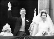 <p>Princess Margaret and the newly titled <a href="https://www.townandcountrymag.com/society/tradition/a29668117/lord-snowdon-antony-armstrong-jones-princess-margaret-husband-facts/" rel="nofollow noopener" target="_blank" data-ylk="slk:Earl of Snowdon;elm:context_link;itc:0;sec:content-canvas" class="link ">Earl of Snowdon</a> wave to well-wishers on the Buckingham Palace balcony after their ceremony at Westminster Abbey. The Princess paired her <a href="https://www.brides.com/princess-margaret-wedding-5087739" rel="nofollow noopener" target="_blank" data-ylk="slk:silk organza Norman Hartnell;elm:context_link;itc:0;sec:content-canvas" class="link ">silk organza Norman Hartnell</a> wedding dress with the Poltimore tiara. </p>