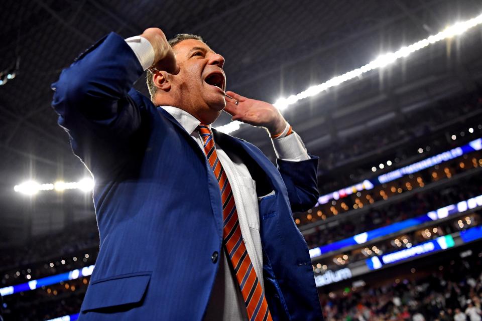 Auburn coach Bruce Pearl cheers with the crowd before an NCAA tournament game against Virginia. Apr. 7, 2019