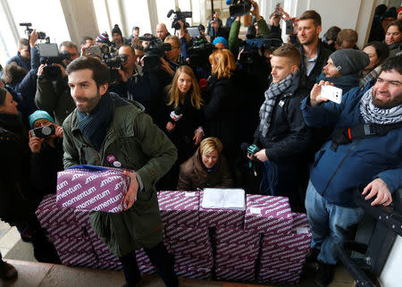 A leader of political movement Momentum Andras Fekete-Gyor holds one of the boxes consisting over 266,000 signatures from Budapest voters who want a referendum on Budapest's bid to host the 2024 Summer Olympics in Budapest, Hungary February 17, 2017. REUTERS/Laszlo Balogh