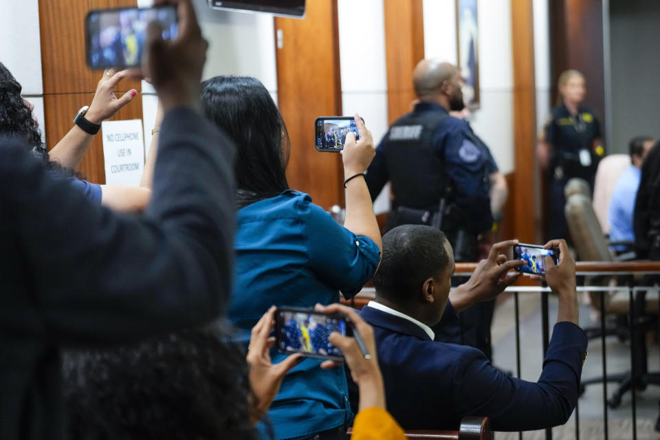 CORRECTS NAME: Reporters use their phones to take photos of Johan Jose Martinez-Rangel, one of the two men accused of killing 12-year-old Jocelyn Nungaray, as he is led from the courtroom on Tuesday, June 25, 2024 in Houston. Capital murder charges have been filed against Martinez-Rangel and Franklin Jose Pena Ramos in the strangulation death of the 12-year-old. (Brett Coomer/Houston Chronicle via AP)