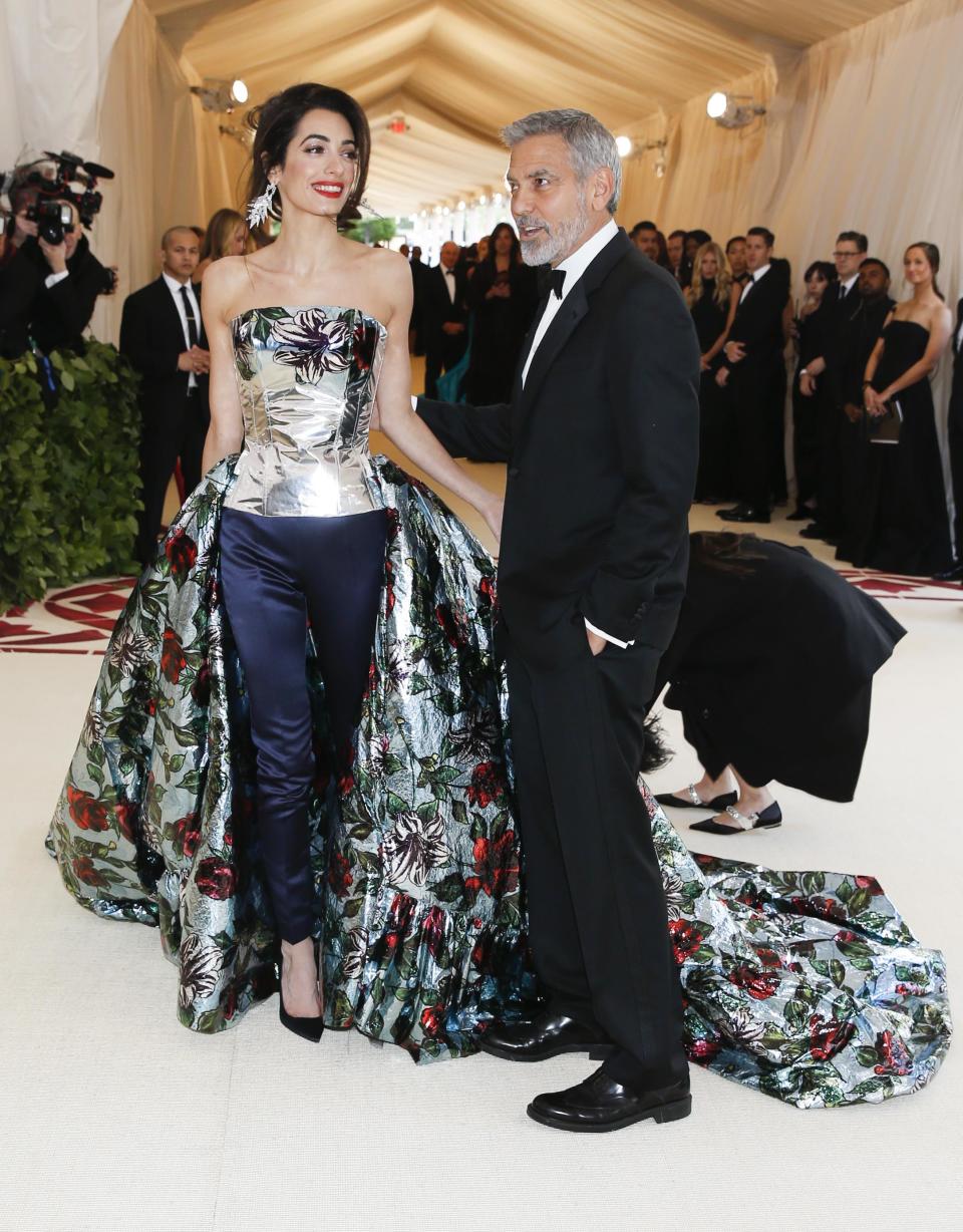 Actor George Clooney and his wife Amal Clooney arrive at the Metropolitan Museum of Art Costume Institute Gala (Met Gala) to celebrate the opening of “Heavenly Bodies: Fashion and the Catholic Imagination” in the Manhattan borough of New York, U.S., May 7, 2018. REUTERS/Carlo Allegri