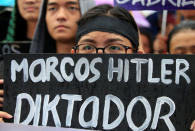 A protester holds a placard during a protest at Luneta park, metro Manila, Philippines November 25, 2016, denouncing the burial of late dictator Ferdinand Marcos at the Libingan ng mga Bayani (Heroes' cemetery) last week. REUTERS/Romeo Ranoco