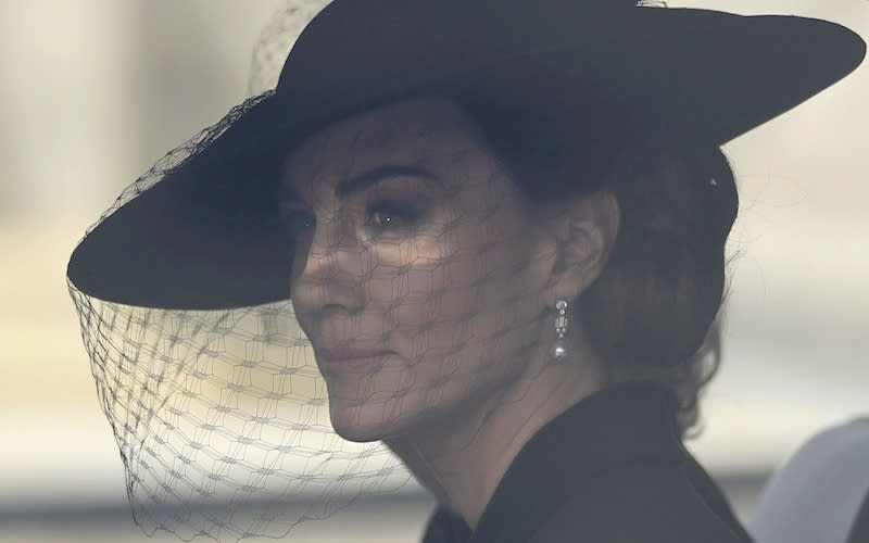 Kate, Princess of Wales, sits in a car following behind the coffin of Queen Elizabeth II being carried along The Mall in London, on its way to Windsor Castle.