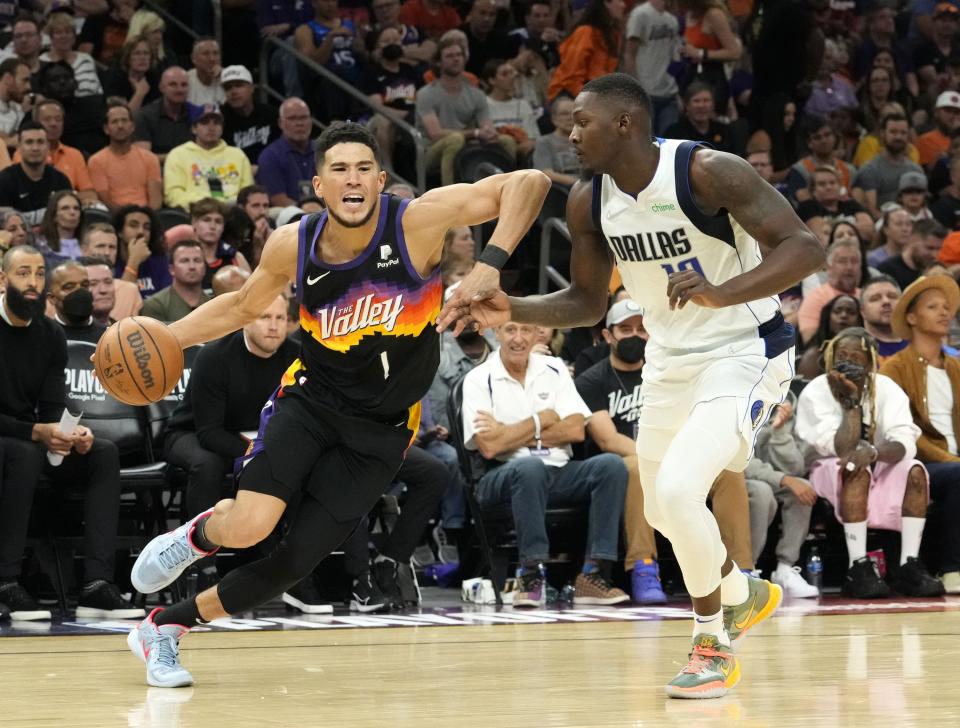 May 15, 2022; Phoenix, Arizona, USA; Phoenix Suns guard Devin Booker (1) drives around Dallas Mavericks forward Dorian Finney-Smith (10) during game seven of the second round for the 2022 NBA playoffs at Footprint Center.